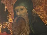 painting of a bearded man with a black hat and a green robe