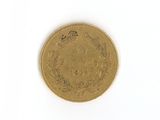 a gold coin on a white surface with a white background