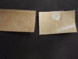 two pieces of brown paper sitting next to each other on a black surface