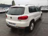 the back of a white volkswagen suv parked in a parking lot