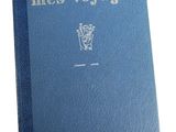 a blue book sitting on top of a table next to a white wall