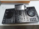 a dj controller sitting on a table next to a cd player