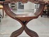 a wooden chair that is sitting in the middle of a room