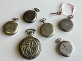 many different types of pocket watches on a white surface