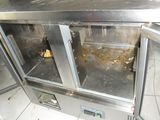 an image of a dirty kitchen with the door open