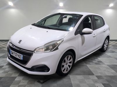 the small white car is parked in the room on a checkered floor