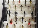 many different types of flies in a black case