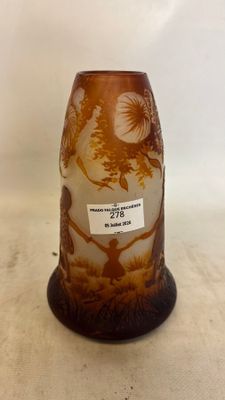 a brown vase with a design on it on a table