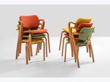 three chairs with different colored cushions sit side by side on a white surface