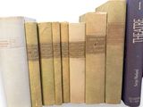 several books are stacked on top of each other on a shelf