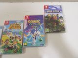 three nintendo wii games sitting on a white table