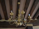a gold chandelier hanging from the ceiling in a room