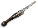 an old silver plated gun with a wooden handle on a white surface
