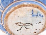 a blue and white bowl sitting on a white surface