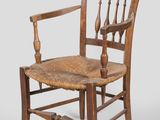 an old wooden chair with a woven seat on a white background