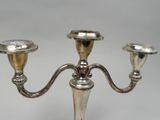 silver plated candelabra with two candles on a stand