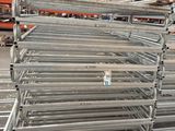 many racks that are stacked up in a warehouse