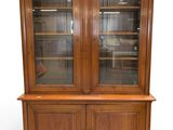 an image of a wooden china cabinet with glass doors