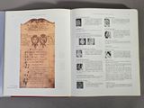 an open book with pictures of people on it on a table