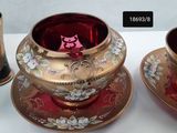 two cups and saucers sitting on a table next to each other