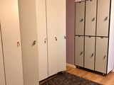 many white lockers in a room with a brown rug on the floor
