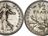 a silver coin with the image of a woman in a dress