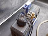 a small air compressor sitting on top of a metal counter