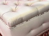pink tufted ottoman with tassels and fringes