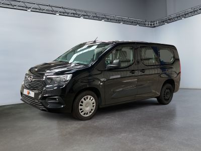 the black van is parked in a large room with white walls