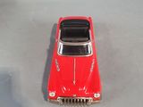 a red toy car that is sitting on a table