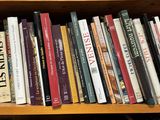 many books on a wooden shelf in a room
