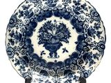 an image of a blue and white plate with a flower arrangement on it