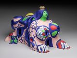 sculpture of a woman laying on her stomach with a crown on her head
