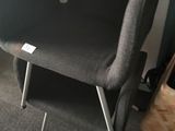 a chair that is next to a table in a room