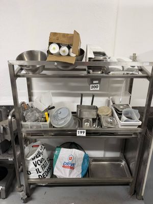 a metal shelf that has a bunch of items on it