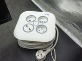 a white box with a bunch of plugs attached to it