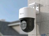 a close up of a camera mounted on the side of a building