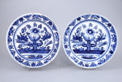 pair of blue and white plates with flowers and birds on them