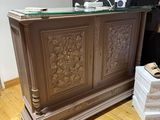 a wooden desk with a glass top in a room