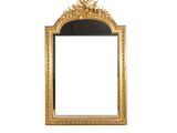 an image of a gold framed mirror on a white wall