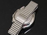 a close up of a watch on a black surface