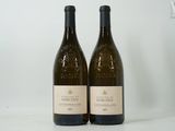 deux bouteilles de vin posées sur une table l'une à côté de l'autre