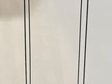 a white towel sitting on a stand on a white background