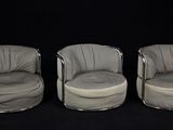 three chairs are lined up in a row on a black background