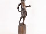 bronze statue of a man holding a sword on a pedestal