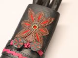 a black leather case with a flower on it