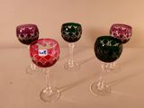 three wine glasses are lined up in a row on a table