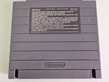 an old nintendo game console sitting on a white surface