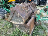 a tractor that is sitting in the grass next to a bulldozer