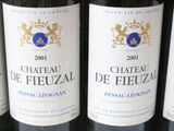 several bottles of wine are lined up on a shelf